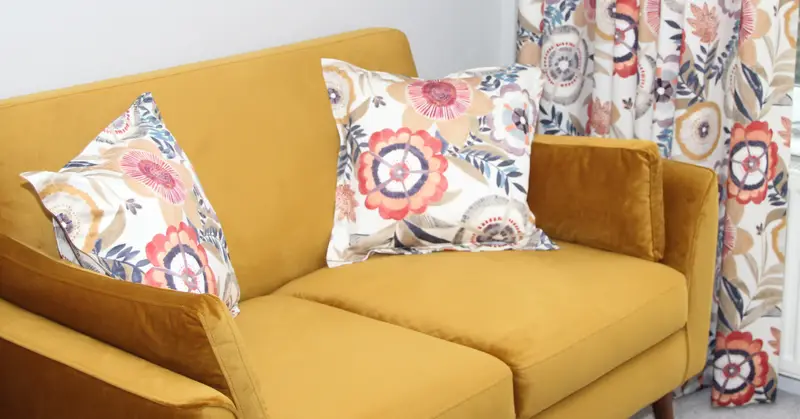 Floral cushions on a sofa by Heather Horrocks Leigh
