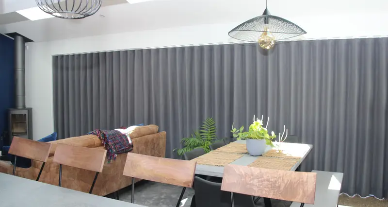 Grey wave curtains in an open plan room by Heather Horrocks Leigh
