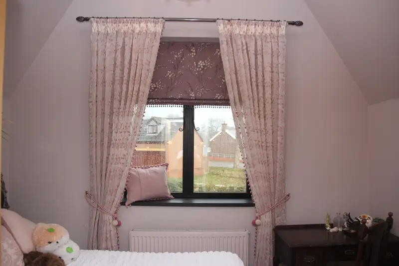 Pink curtains and voile in a bedroom by Heather Horrocks Leigh